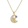 Macro shot of gold-plated crescent moon and bear pendant with sparkling zircon stones - Blue