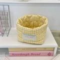 Detail of yellow checkered quilted fabric storage basket with soft texture and brand label - 12x10cm / Yellow