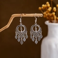 Close-up of vintage silver tassel earrings with leaf charms hanging on a wooden branch - E2874-38/Leaf Hollow Carved