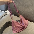Detail of pink rhinestone handbag featuring a decorative knot on the sparkling strap - Standard Size / Light Purple
