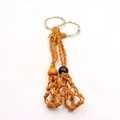 Close-up of ginger yellow hand-woven net pouch keychains with metal rings and beads - 2 Pcs/Set / Coffee