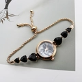 Detail of golden watch with black marble dial and heart-shaped charms on bracelet - Rose Gold Black