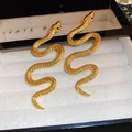 Macro detail of golden snake stud earrings with textured scales and green zircon eyes - Gold Snake Shape Green Eye Accent Style (38# Silver Earring Post-Gold)