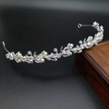Detail of silver bridal crown featuring white pearls and rhinestone floral vine design - Style 4