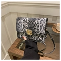 Detail of grey leopard print crossbody bag featuring a vintage gold square metal lock - Black