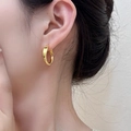 Minimalist golden round hoop earrings worn by a female model in vintage style - Minimalist Shiny Gold Hoop