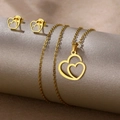 Polished gold heart jewelry set including necklace and earrings on a grey display - Linked Hearts (TZ-470)