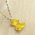 Detail of gold necklace with bear pendant featuring resin finish and zircon star accents - Yellow Lip Chain