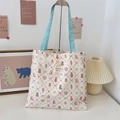 Detailed close-up of pink floral canvas tote bag featuring cute puppy print and blue handles - Lace Pastry