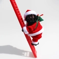 Animated black Santa Claus figure climbing a red ladder with green gift bag decoration - Black Face / Red Ladder