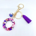 Letter resin keychain with purple glitter, matching tassel and gold hardware - Letter O
