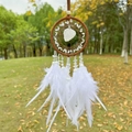 Detail of dream catcher with white feathers and natural stone hanging on a tree branch - Clear Quartz Brown Hoop