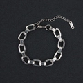 Close-up of silver titanium chain bracelet with oval links and K18 hallmark detail - Flat Oval Link (Style 9) / Silver