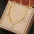 Golden double layer necklace featuring snake chain and evil eye heart pendants - Heart Style