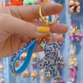 Blue rhinestone teddy bear keychain with matching blue suede strap and gold ring - Blue Gradient