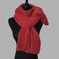 Detail of red knit scarf with soft cashmere texture wrapped around a black mannequin neck - Wine Red