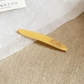 Détail d'une barrette en résine ambrée avec gravure Barrette La France et clip doré - Jaune Ambre