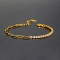 Macro shot of gold paperclip chain bracelet with round white zirconia in mirror reflection - Gold Bracelet
