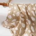 Muslin baby blanket in khaki with white irregular dots on a rustic wooden branch - Khaki White Dot