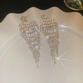Detail of silver tassel earrings with zircon flower studs on a white ceramic plate - Style 1 Silver Post / Gold