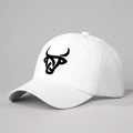 Detailed view of black bull head embroidery on white cotton six-panel baseball cap - Adjustable / White