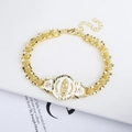 Macro detail of 18K gold-plated chain bracelet with Guadalupe medal and rose engravings - White Oval Guadalupe Medal Rose Chain Bracelet