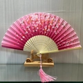 Pink silk folding fan with cherry blossom pattern and pink tassel on bamboo frame - Floating Flowers (Pink)