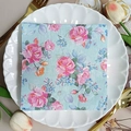 Light blue floral paper napkin with pink roses on a decorative white ceramic plate - Blue Base Pink Rose (1076)