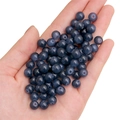 Deep blue round glass beads for DIY jewelry making held in hand for size context - Grey Blue approx 50pcs/pack