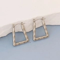 Detail showing irregular geometric silver earrings with bamboo texture on a white stone - Silver Style K7-80