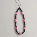 Detail of beaded phone strap with black round beads and pink resin bow charms - Red Bowtie Style Phone Chain