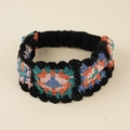 Detailed close-up of a colorful crochet granny square headband with floral knit patterns - Granny Square Splicing / Black (Retro Color Splicing)