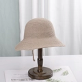 Japanese style beige woven straw bucket hat on a vintage wooden hat stand display - M (56-58cm) / Dark Khaki