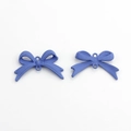 Detailed view of matte purple bow alloy pendants with dual holes for DIY jewelry making - Purple