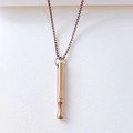 Detail showing a rose gold mindfulness breathing whistle pendant on a box chain. - Cylindrical Tube Necklace / Mesh Chain / Rose Gold