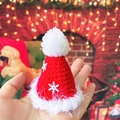 Detailed view of mini knitted Christmas hat for pets with snowflake accent and red finish - Red Christmas Hat