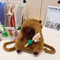 Cute brown capybara plush backpack with a pink flower accessory in a bright room - Holding Pink Flower (Plush Strap)