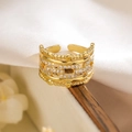 Detailed view of hollow geometric gold ring with cubic zirconia on a wooden surface - Adjustable Open / Hollow Geometric Style / Gold