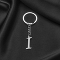 Polished stainless steel keychain featuring a silver letter I pendant on black silk - Letter I