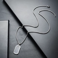Detail shot of a silver box chain with a blank rectangular tag pendant in stainless steel - Silver Necklace (L490-A)