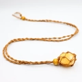 Handmade woven necklace featuring a natural raw yellow crystal stone in brown cord net - Citrine