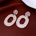 Detail view of silver geometric earrings with textured metal finish on red velvet fabric - 12# Silver Earring Post - Silver - White - Hammered Hoop