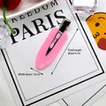Close-up of pink resin hair clip with 6cm length dimension on a white display card - Peach Pink