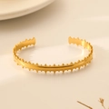 Detailed view of gold stainless steel cuff bracelet with scalloped crown edges - Gold Sawtooth