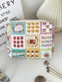 Detailed close-up of a quilted floral makeup bag with cute cartoon icons and zipper closure - Patchwork Floral Girl (Gold Label)