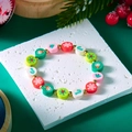 Bracelet de Noël en perles avec pères Noël et flocons sur fond vert de fête élégant - Style 1