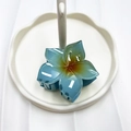 Blue gradient flower hair claw clip with orange center on a white jewelry tray - Blue (Five-petal Flower)