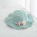 Detail of mint green straw sun hat featuring wavy brim with pearls and fabric flowers - Lake Blue Single Hat