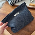 Detail of dark blue herringbone denim makeup bag with a simple wish fabric label - Pure Denim Blue