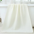 Soft white cotton bath towel with waffle weave texture draped on a white bathtub - 70*140cm / White